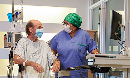 Health care worker is caring for a patient on the hospital in-patient unit, and is inputting patient information in new electronic health record